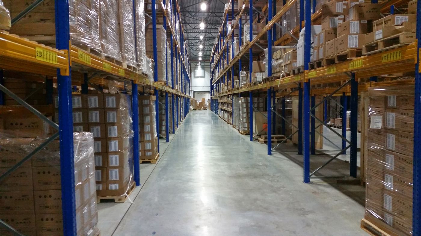 Warehouse team member checking stock on shelves of medical supplies
